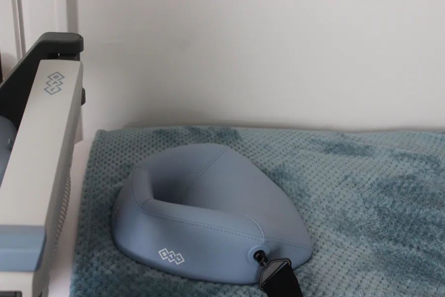 A treatment table at the Centre set up for an EXOMind session, with a blue face-cradle pillow and a soft teal blanket.