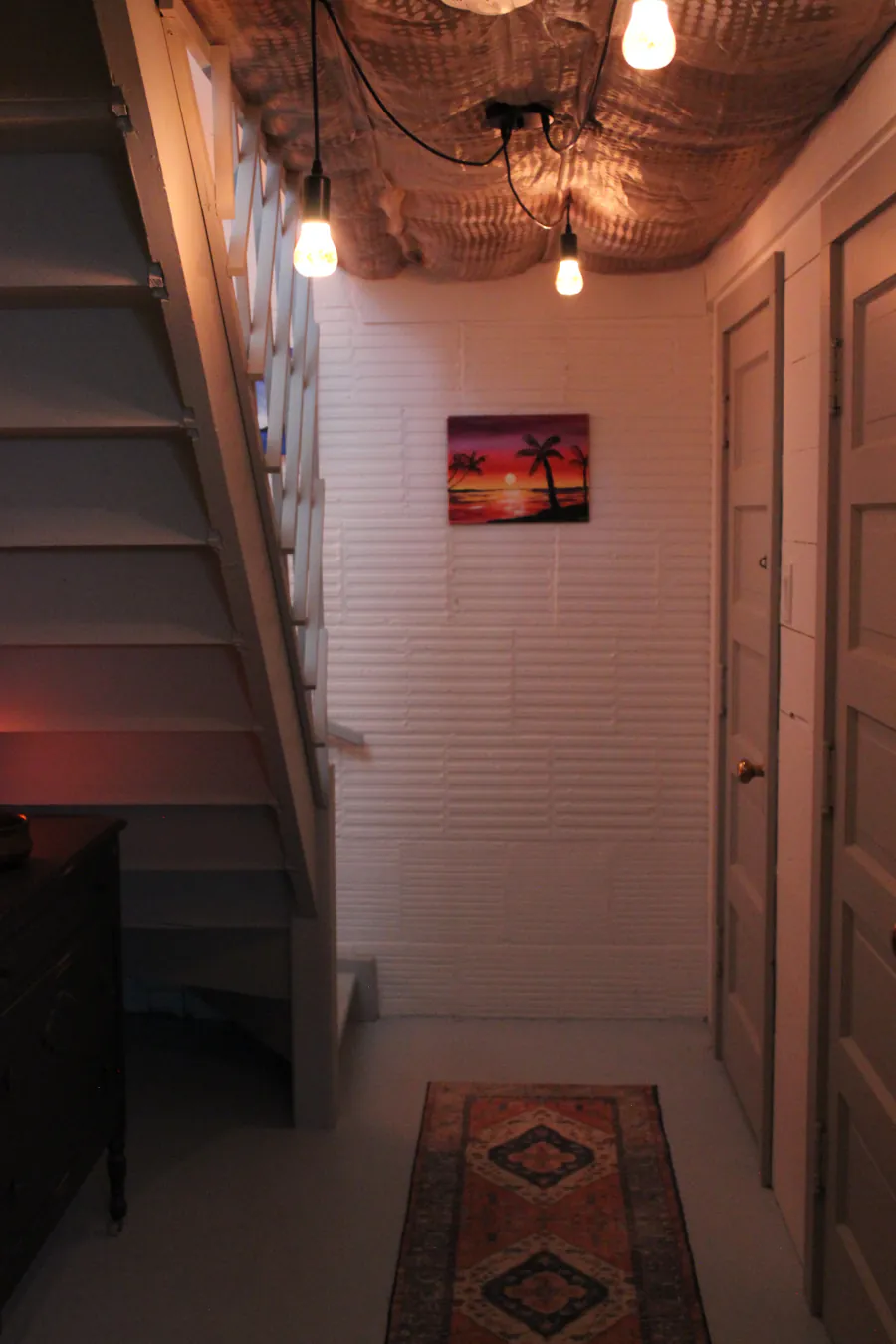 A warmly lit hallway inside the Centre with a pendant light.