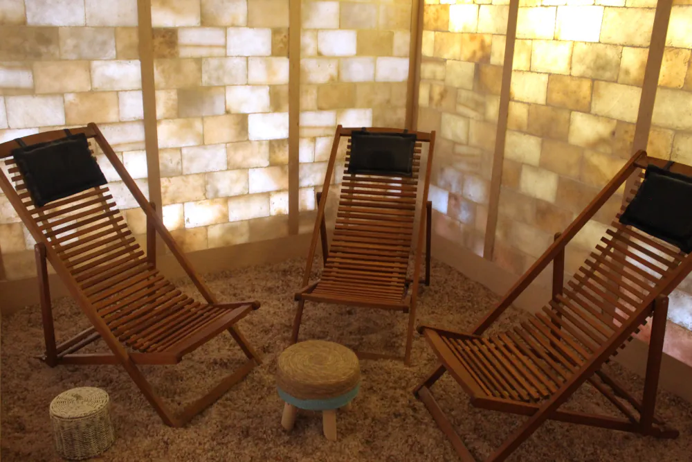 The Centre's salt sanctuary — wooden sling loungers on salt crystal, with a back-lit salt-brick wall.
